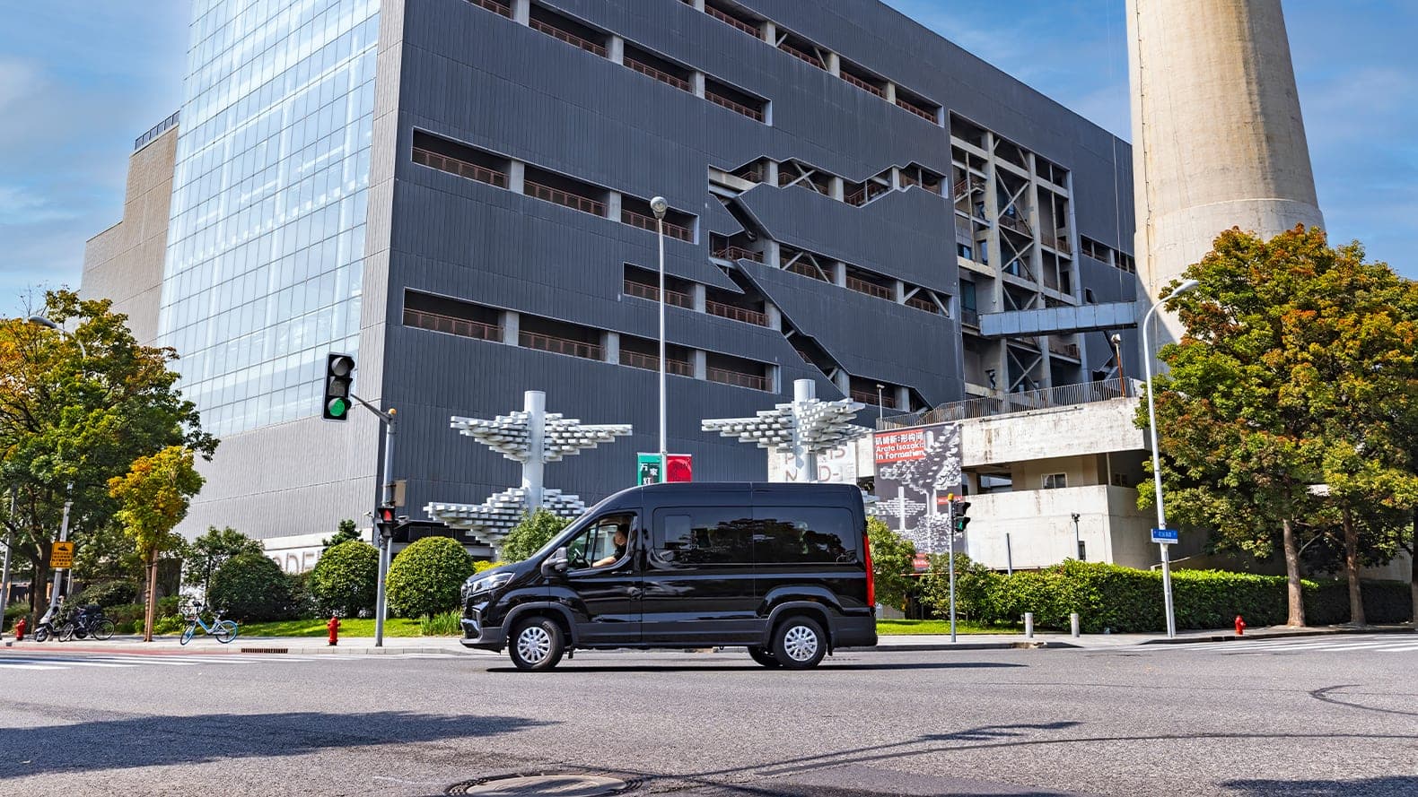 2026 MAXUS V90 — Large Diesel Van and 9–15 Seat Minibus for export, side profile in an urban setting